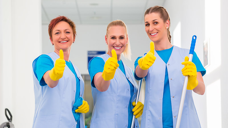 Cleaning ladies working in team showing the thumbs up sign